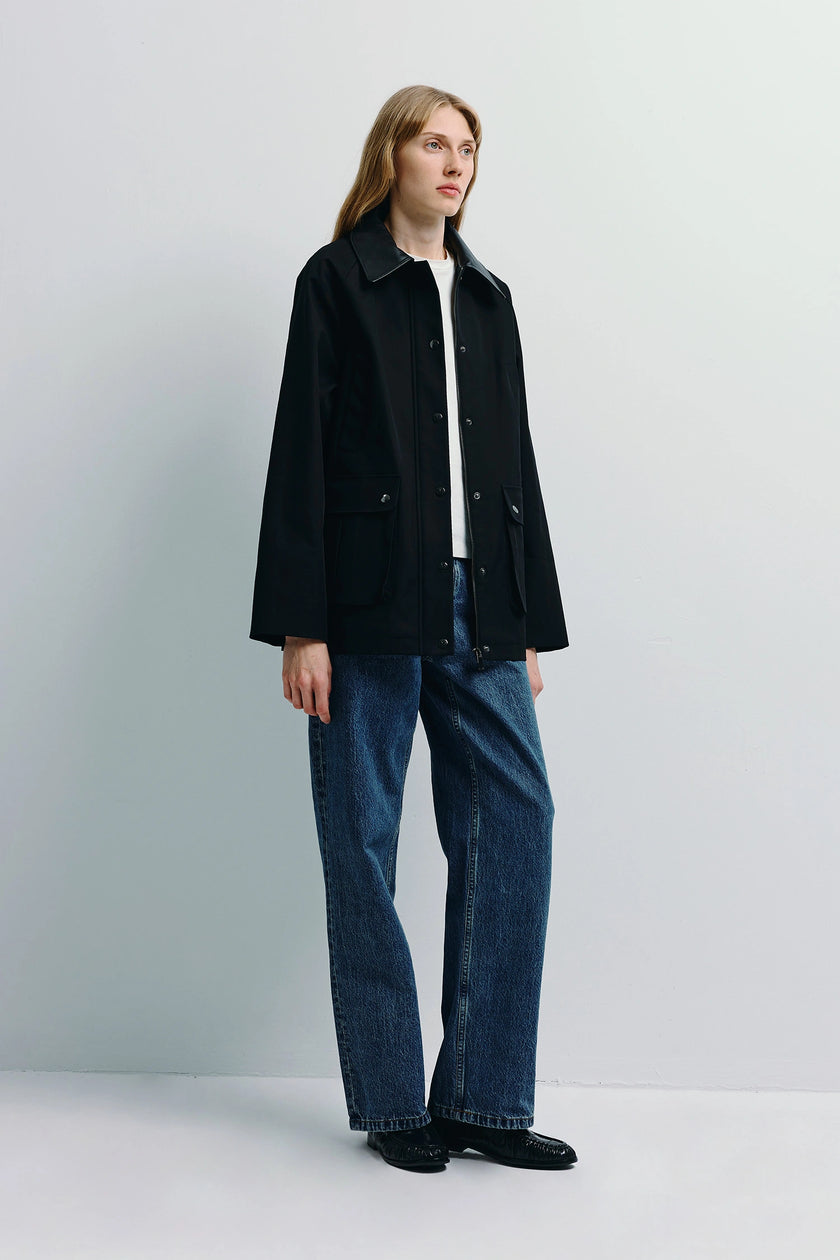 Black Roth Leather Barn Jacket with leather collar, worn by a woman, crafted from structured cotton, paired with jeans