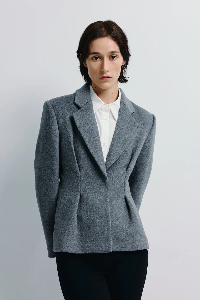 Trenton Pleat Waist Wool Blazer in gray. Tailored wool-blend blazer with structured shoulders and pleated waist.
