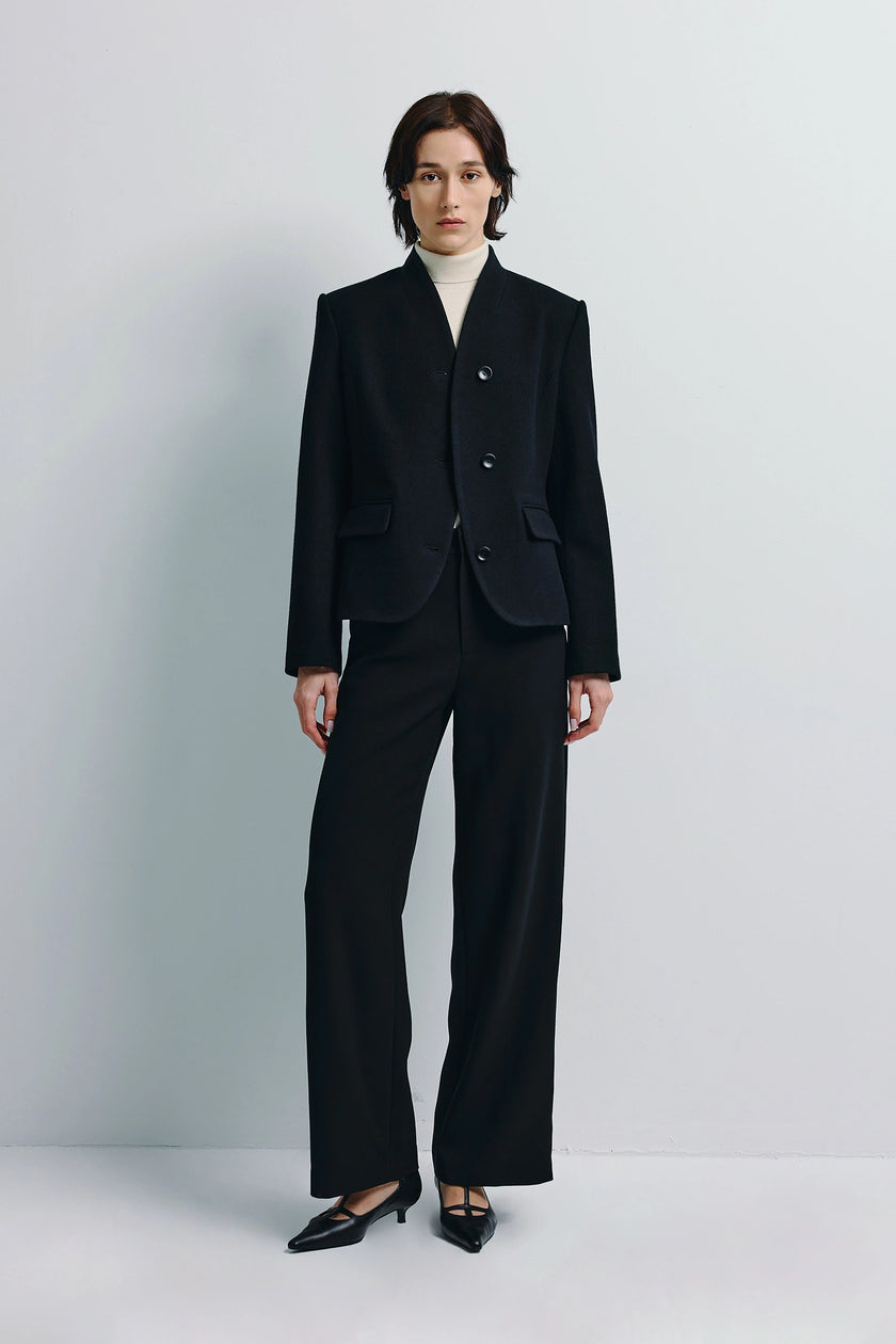Camberly Collarless Blazer in black, wool-cashmere-silk blend, modern tailoring, paired with black trousers.