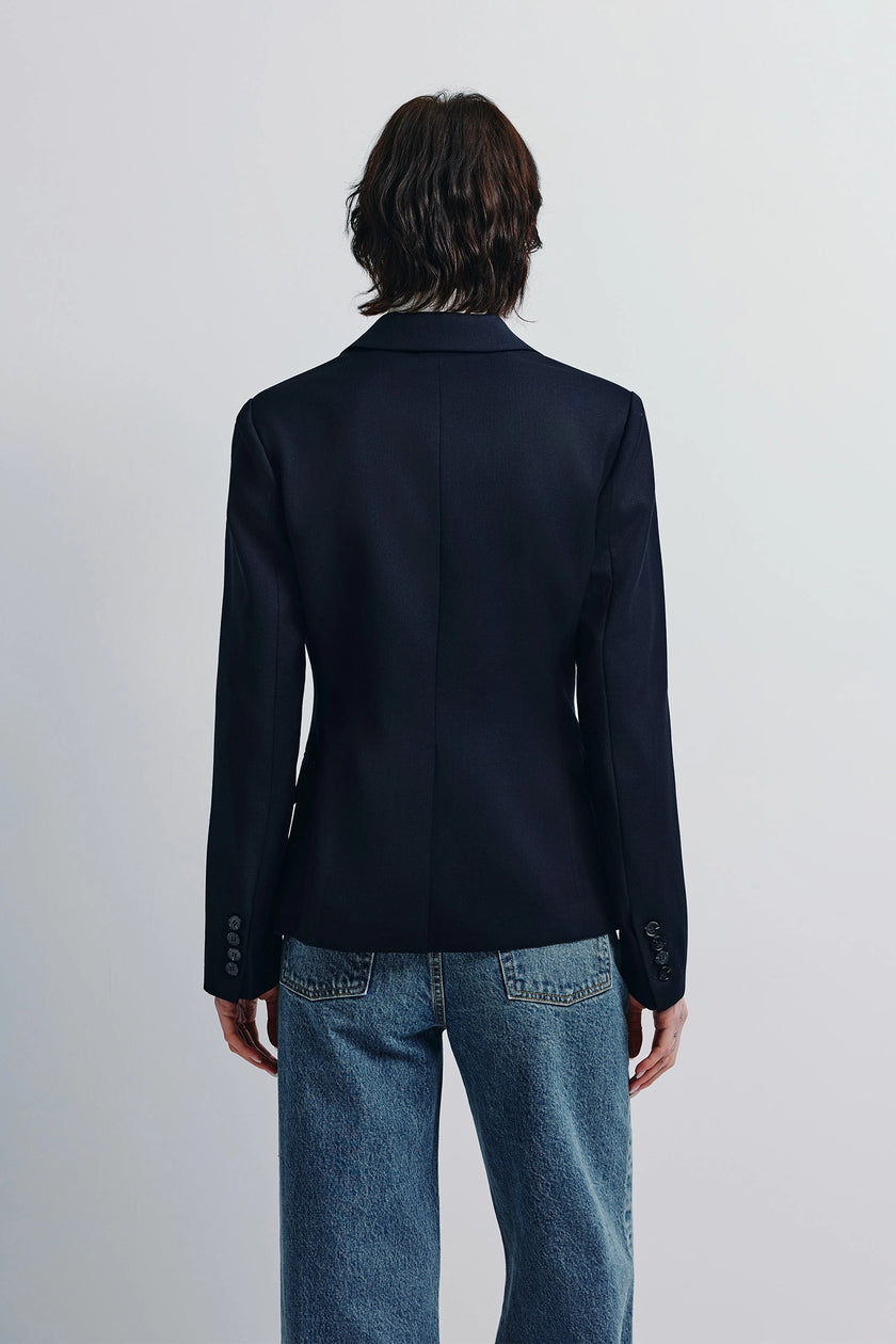 Navy Jin Slim Waist Wool Blazer with slim fit, paired with blue jeans. Back view