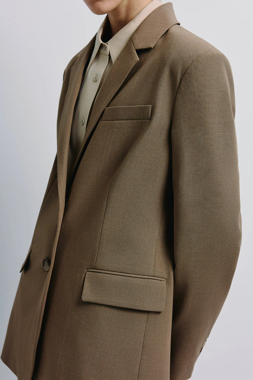 Brown Walker Oversized Blazer with flap pockets, tailored structure, and a light-colored shirt