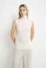 A model wearing a Rue Sophie creme sleeveless mock-neck top with extended shoulders, a softly draped neckline, and relaxed straight fit, full-length front view.