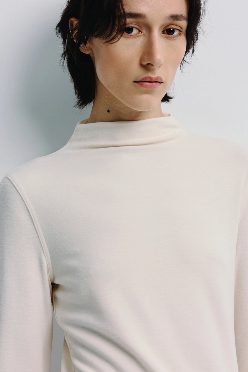 Cream Morgane High Neck Knit Top. Soft-touch knit with natural stretch, modern style, long sleeves and easy fit.