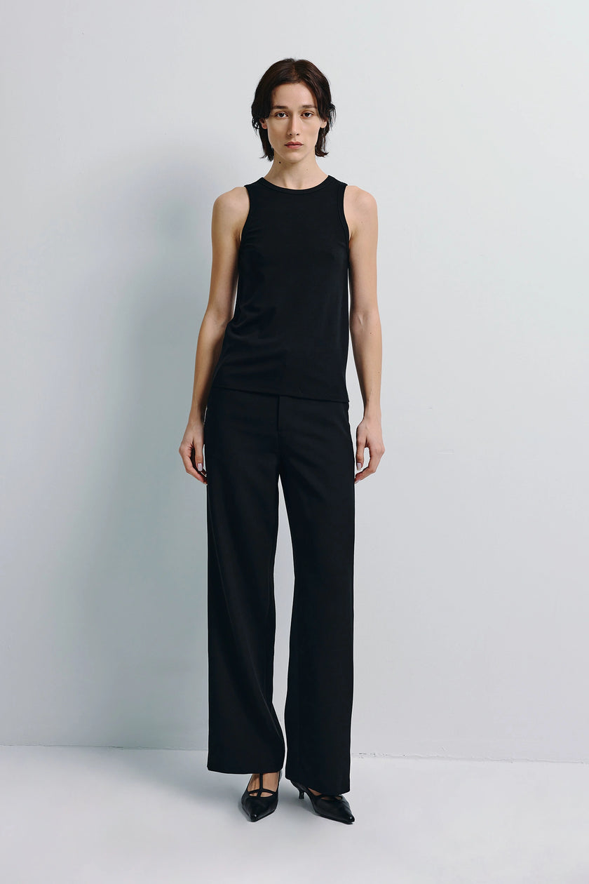 Black Béri High Neck Tank Top and trousers outfit. Soft wool-blend, minimalist layering.