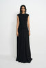 A model wearing a sleeveless black maxi dress with a textured knit bodice and a flowing chiffon skirt, standing against a plain light gray studio background.
