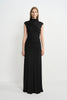 A model facing forward in a black maxi dress with a high neck, diagonal bodice folds and ruched hips, styled with a silver cuff.