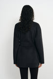Back view of a heather-grey short coat on a model, showing the belt across the waist, long sleeves and straight hem above black leggings.