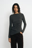 Front close-up of a model in a charcoal-heather long-sleeve top, showing the boat neckline, horizontal waist gathers and slanting hem over brown trousers.