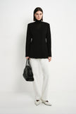 A model wearing the Rue Sophie Marion Side Slit Jacket in black with a collarless V-neckline, structured shoulders, and a fitted tailored shape, full-length front view.
S424JS561_BLACK-2.jpg	A model wearing the Rue Sophie Marion Side Slit Jack