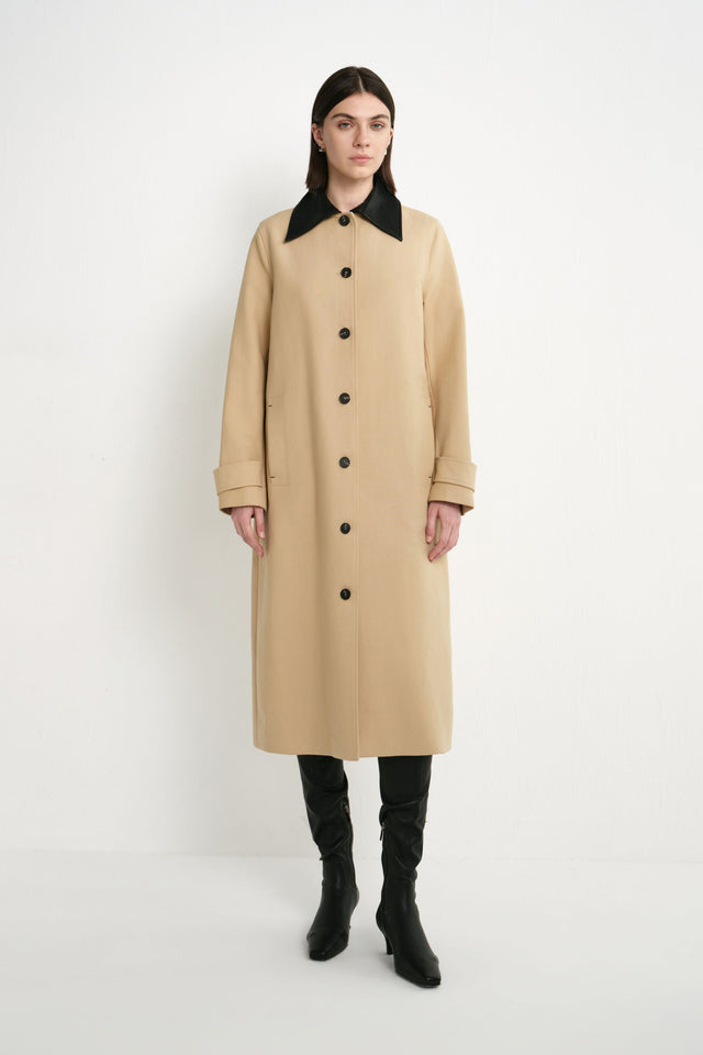 A model wearing the Rue Sophie Vinni Pu Collar Car Coat in khaki with a contrast black pointed collar, black button closure, cuff tabs, and a clean longline silhouette, front view.
