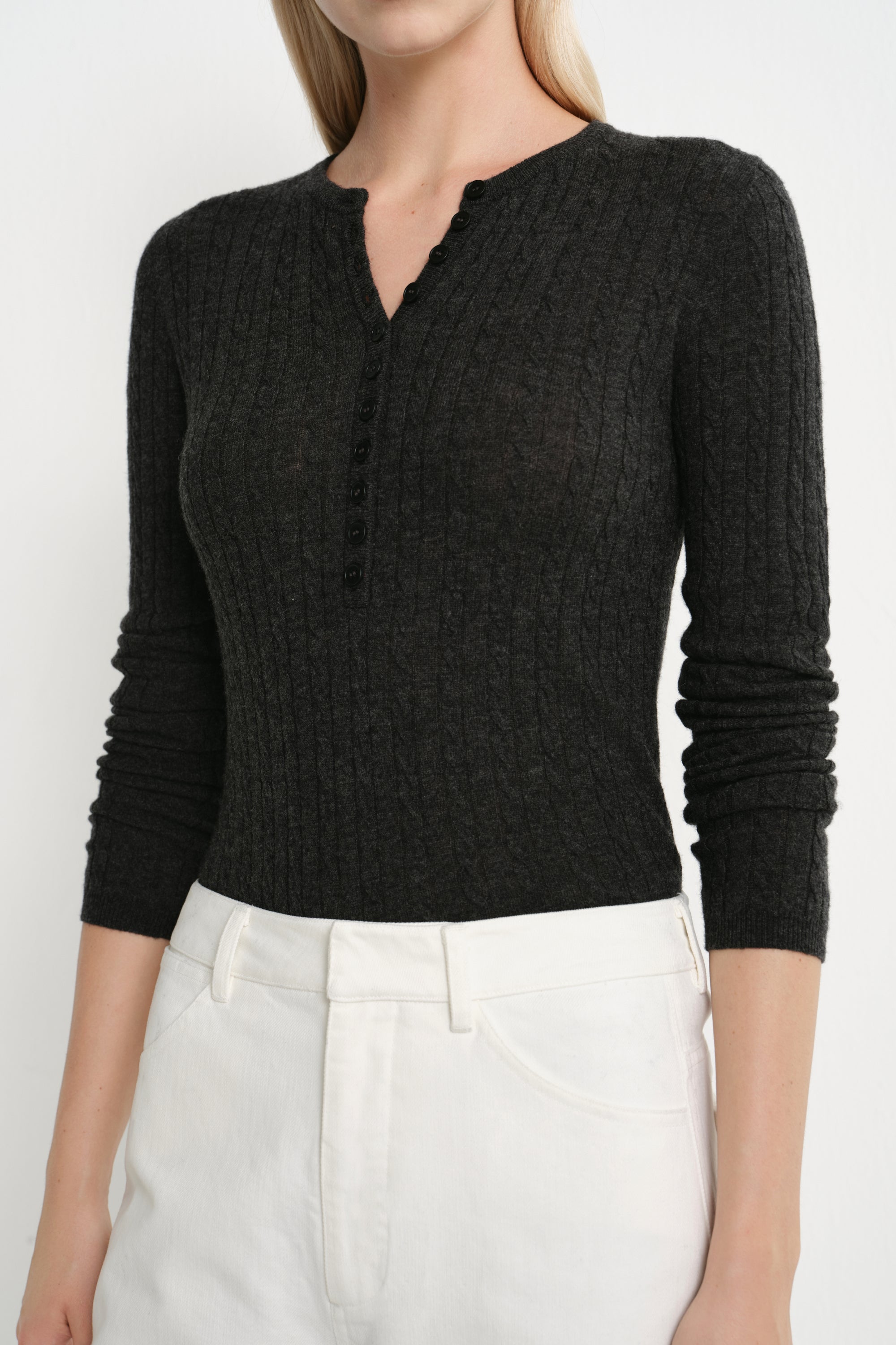 Close-up of the Rue Sophie Richie Button Up Cable Sweater in heather grey, highlighting the cable-knit texture, fitted construction, and small buttoned Henley neckline.