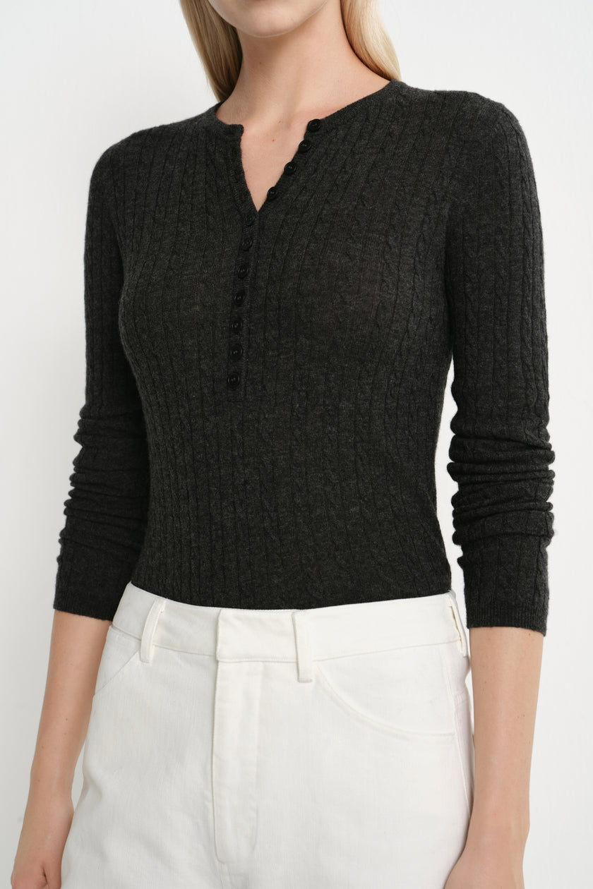 Close-up of the Rue Sophie Richie Button Up Cable Sweater in heather grey, highlighting the cable-knit texture, fitted construction, and small buttoned Henley neckline.